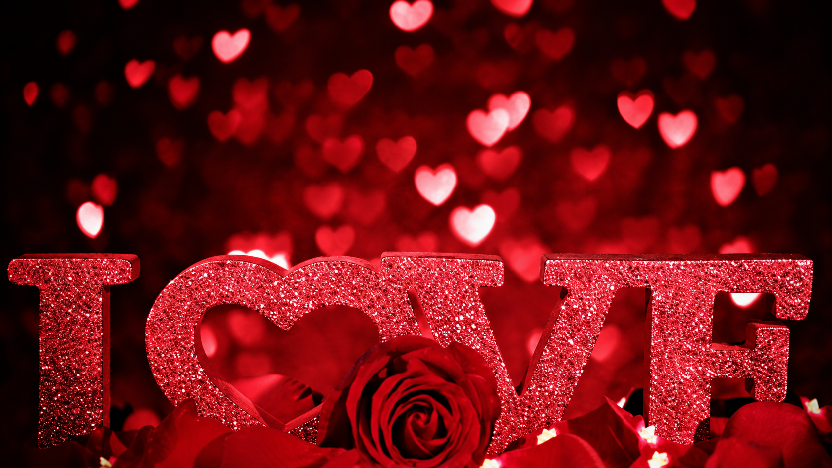 The complete word LOVE in sparkling red letters, with a heart and rose